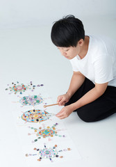 Mandala pattern with crystal and Asian women. a creator