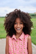 © guille Faingold/Stocksy - Cheerful lovely girl with afro hairstyle.