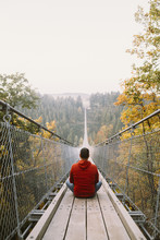 Man On A Long Bridge In Nature