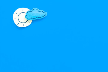 Wall Mural - clear and cloudly weather icons on blue background top view copy space