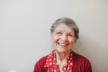 Portrait Of Content Senior Woman On Plain White Background