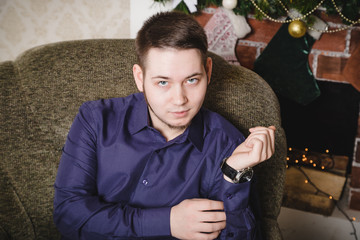 Wall Mural - Handsome guy in the room decorated for Christmas