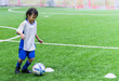 © junce11 - Little Asian girl is training in indoor soccer field