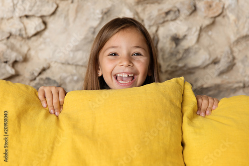 Laughing Little Girl Peeking Behind Yellow Couch Buy This Stock