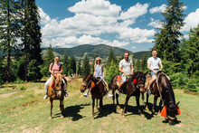Group Of People Riding Horses In The Mountains