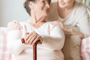 Sticker - Close-up of elderly woman holding walking stick in the nursing house