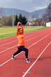 © Novak - Woman doing stretching before running