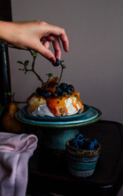 Styling A Pavlova Cake With A Blueberry;;.