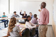 © Monkey Business - Male High School Tutor Standing At Whiteboard Teaching Class