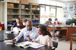 © Monkey Business - High School Tutor Sitting At Desk With Female Student In Biology Class