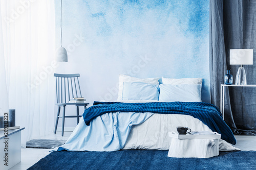 Navy Blue Carpet In Minimal Bedroom Interior With Blanket On