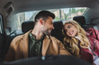 © LIGHTFIELD STUDIOS - beautiful happy young couple smiling each other while sitting together in car