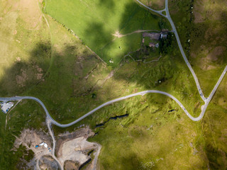 Wall Mural - Aerial top down view of a steep, curving road running up and across a mountain ride (South Wales, UK)