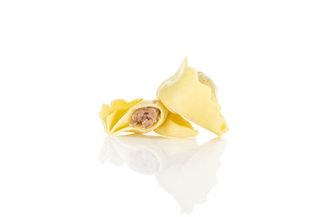 Raw tortellini pasta stuffed with meat isolated on white background Italian traditional.