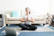© AntonioDiaz - Woman mediating while watching videos online