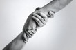 © svetazi - Concept of salvation. Black and white image of the hands of two people at the time of rescue (help).