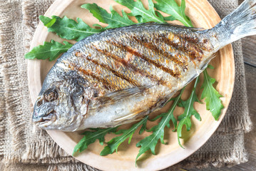 Wall Mural - Grilled gilt-head bream with fresh arugula