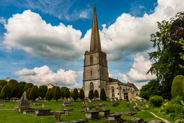 An ancient church and graveyard in the scenic Cotswolds area of England on a summers day (Painswick)