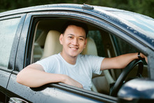 Close Up Of A Handsome Asia Man Siting In His Car.Travel Concept..