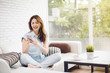 © uinmine - Happy young woman with earphone dancing and listening to music on sofa