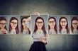 © Feodora - Girl holds and changing her face portraits with different expressions