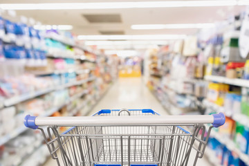 Wall Mural - Supermarket grocery store aisle with empty shopping cart business concept