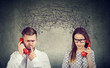 © Feodora - confused couple woman and man talking on the phone exchanging with many negative thoughts