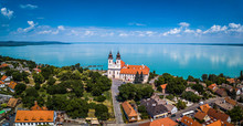 Tihany, Hungary - Aerial Panoramic View Of The Famous Benedictine Monastery Of Tihany (Tihany Abbey) With Beautiful Coloruful Lake Balaton At Background