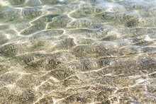 Adriatic Sea Beach Shallow With Water Waves And Sun Reflections