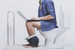 © Vadym Huzhva - Man is working with laptop while sitting on toilet.
