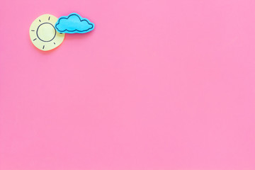 Wall Mural - clear and cloudly weather icons on pink background top view copy space