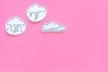 Wall Mural - rainfall forecast concept. weather icons. rainy cloud, lightening on pink background top view copy s