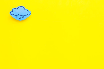 Wall Mural - rainfall forecast concept. weather icons. rainy cloud on yellow background top view copy space