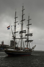 A Three-masted Modern Luxury Clipper With Historical Nineteenth Century Styling Sailing In The North Sea Canal's Mouth Under The Cloudy Gray Sky, IJmuiden, The Netherlands.