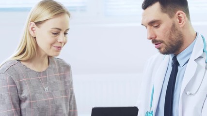 Wall Mural - Beautiful Female Visits Doctor's Office,  He Shows Tablet Computer with Her Medical History They Discuss Her Health and Other Medical Issues. Modern Medical Office. Shot on RED EPIC-W 8K.