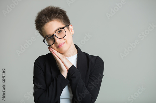 Young Beautiful Girl With Short Hair On Her Head And With Glasses