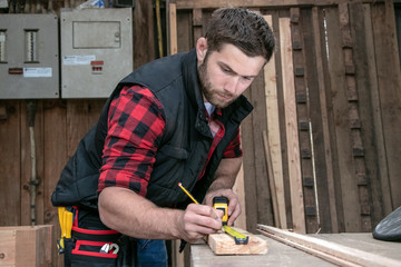 Wall Mural - Carpenter, wood worker work measuring, drilling and making timber product