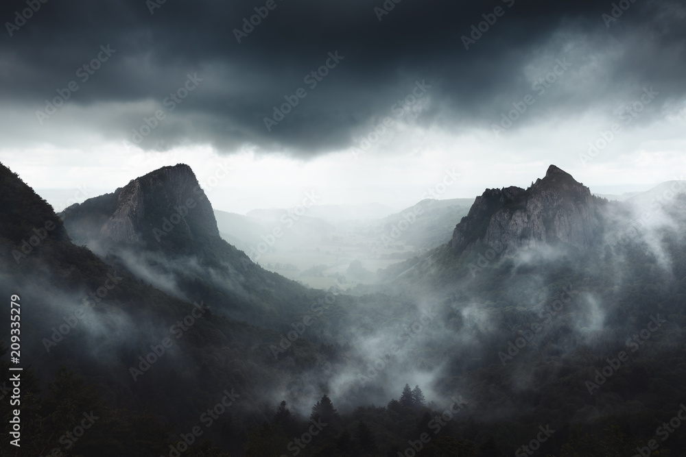 Dramatic weather on Sanadoire and Tuilière rocks in Auvergne province - France - obrazy, fototapety, plakaty 