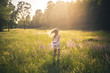 © Westend61 - Back view of girl running on meadow at twilight