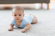 babyhood, childhood and people concept - sweet little asian baby boy lying on floor