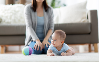 babyhood, childhood and people concept - sweet little asian baby boy and mother at home