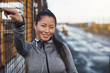 © Flamingo Images - Fit Asian woman listening to music on earphones before running