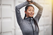 © Flamingo Images - Sporty Asian woman smiling and stretching before exercising