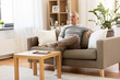 © Syda Productions - leisure and people concept - happy middle-aged man sitting on sofa at home