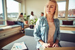 © Flamingo Images - Focused young businesswoman using a laptop at her office desk