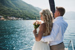 Beautiful stylish bride and groom on the luxury yacht sailing down the sea on their wedding day