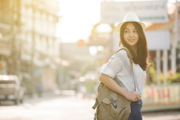 Summer sunny lifestyle fashion portrait of young stylish hipster Asia woman walking on the street, wearing cute trendy outfit