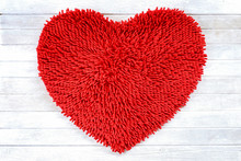 Red Heart Shape Cleaning Feet Doormat Or Carpet Texture On White Wooden Background.