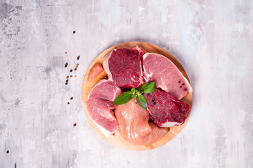 Wall Mural - Different types of meat on a wooden board. Lean proteins.