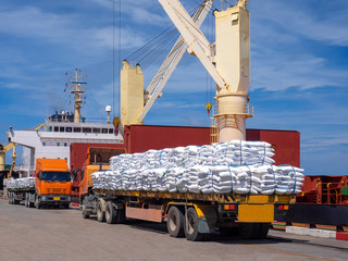 Sticker - Sugar bags are loading in hold of bulk-vessel at industrial port,Pick up sugar bags from truck to  loading on board.